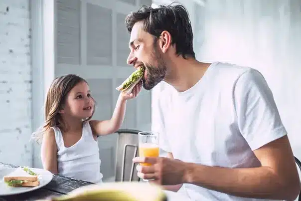 Father and Daughter Eating